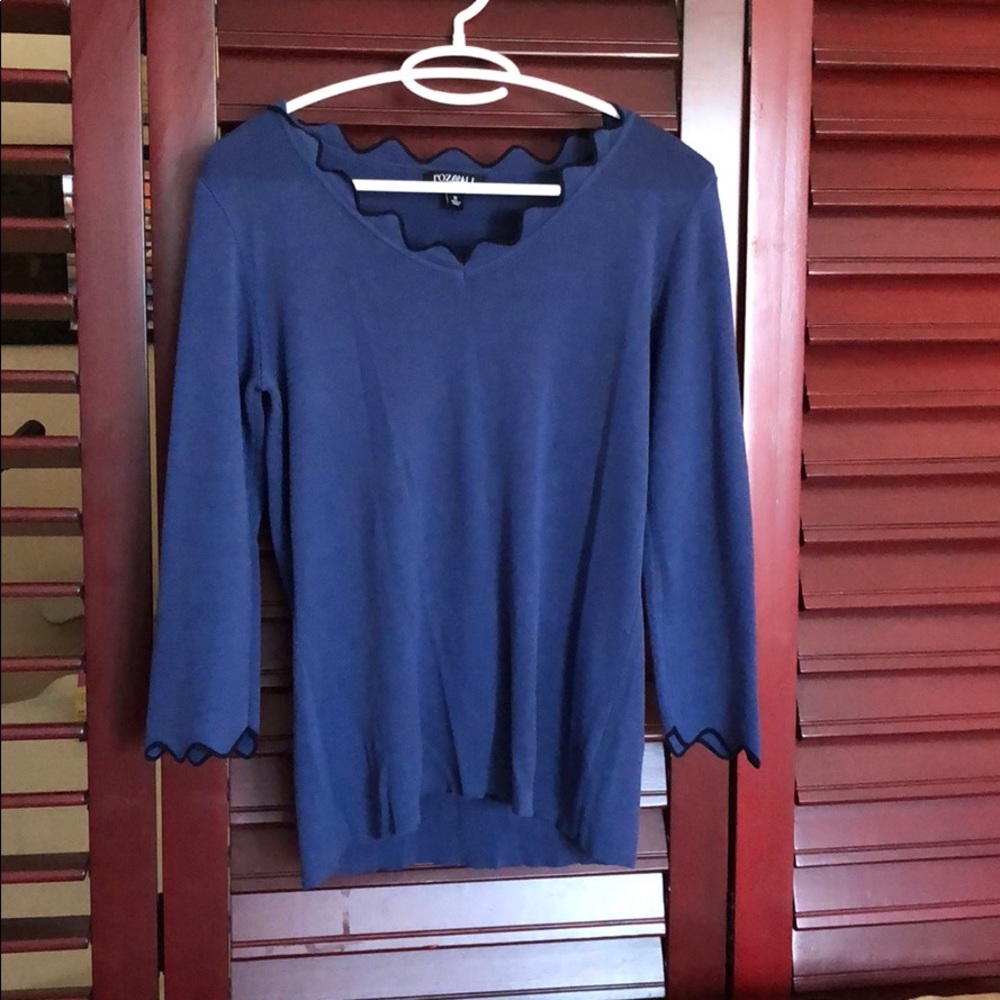 Blue knit sweater with black piping scalloped edge
